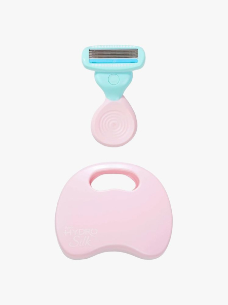 Schick Hydro Silk Mini Razor in branded components on a light gray background